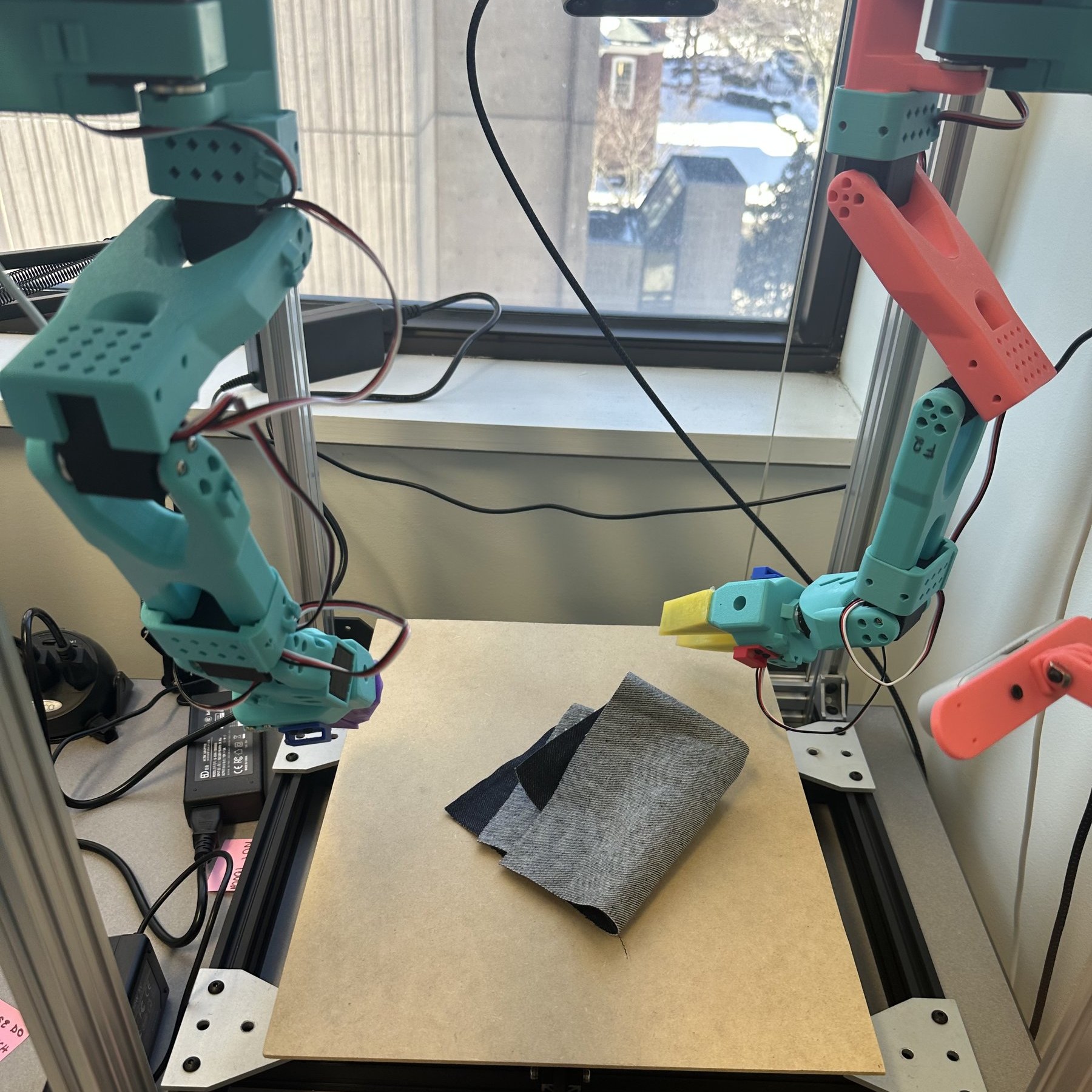 Denim cloth folded on workspace after teleop data collection run