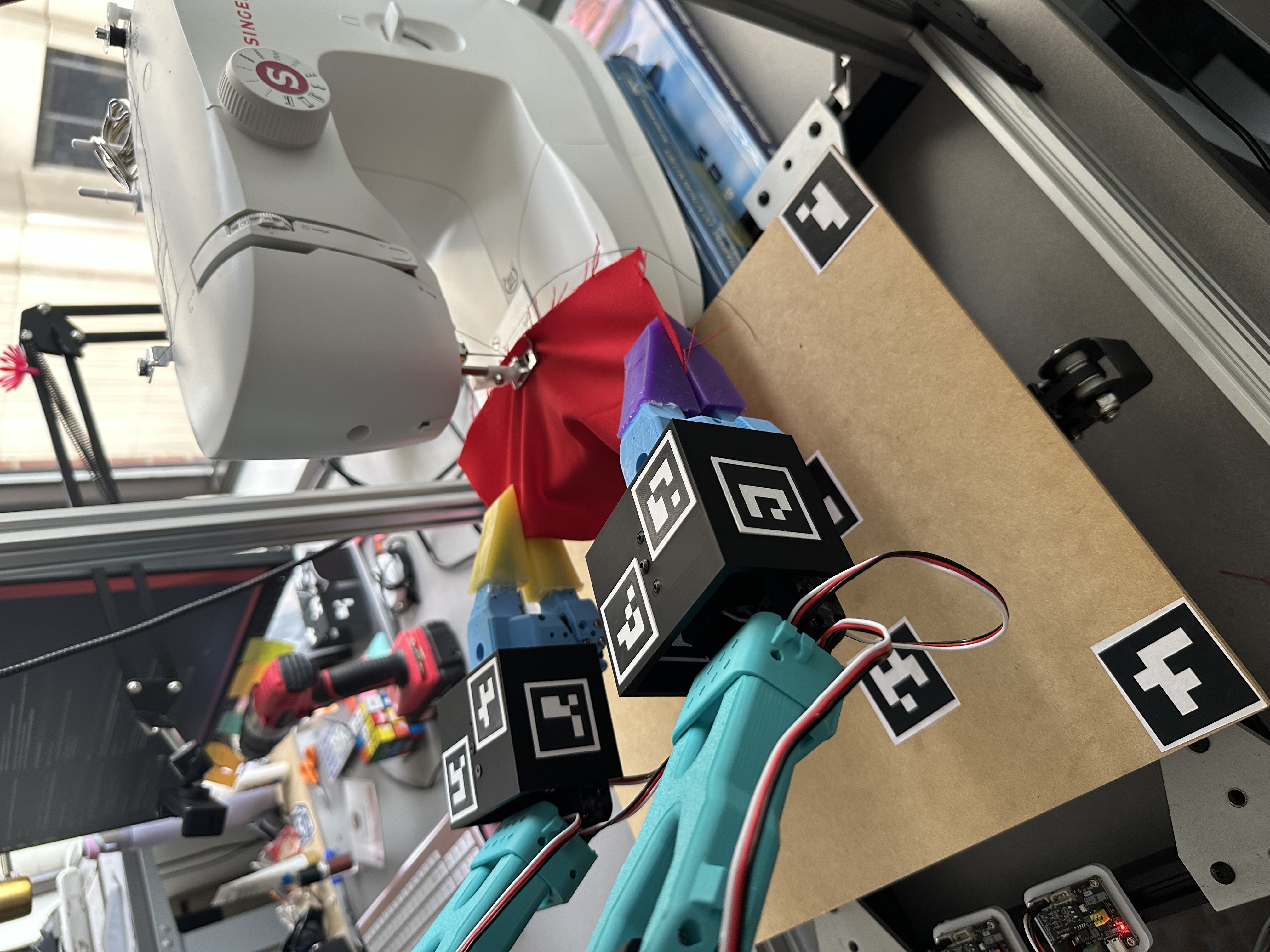 Sewing machine and robot arms — side view