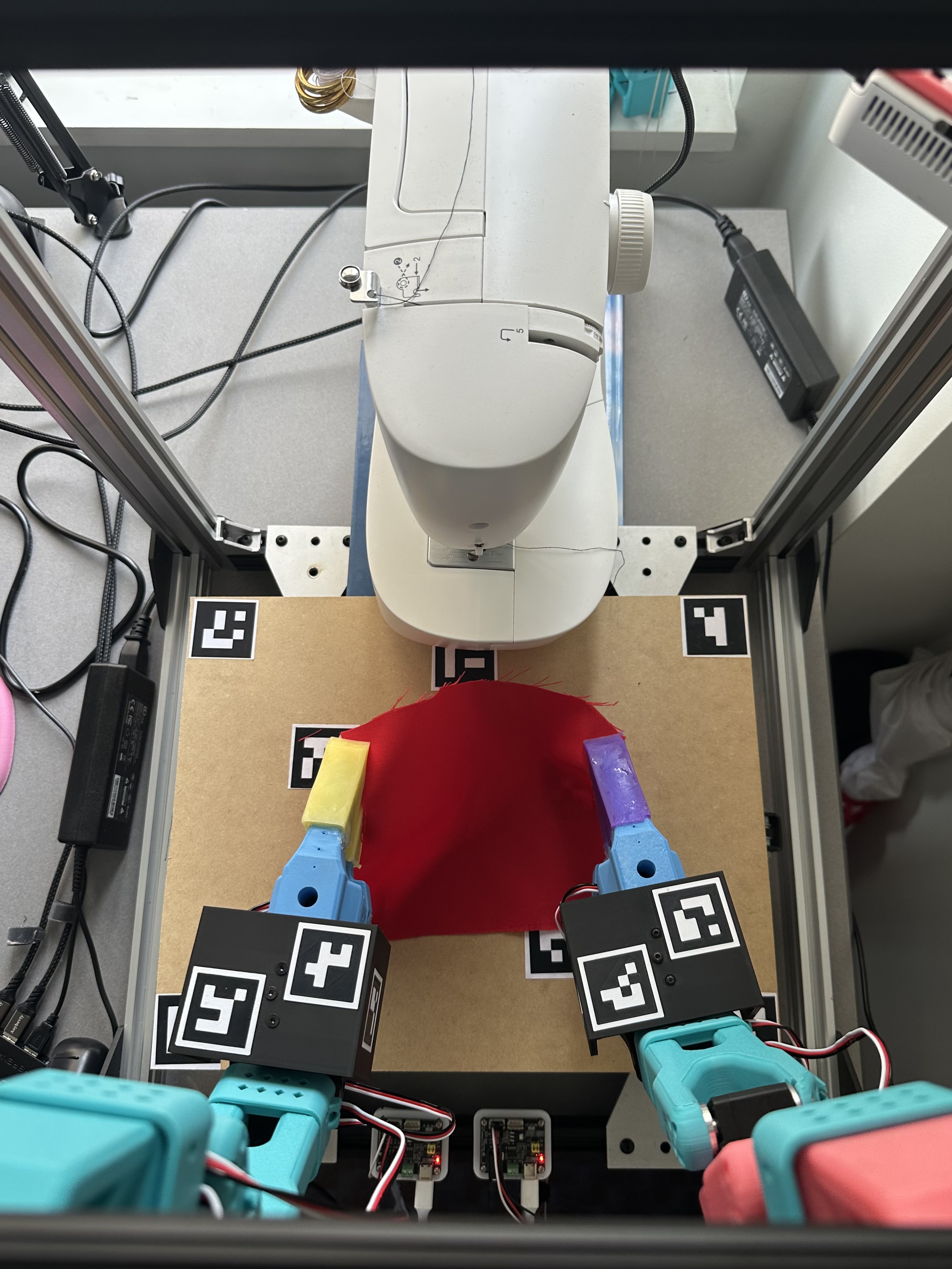 Sewing machine and robot arms — top view